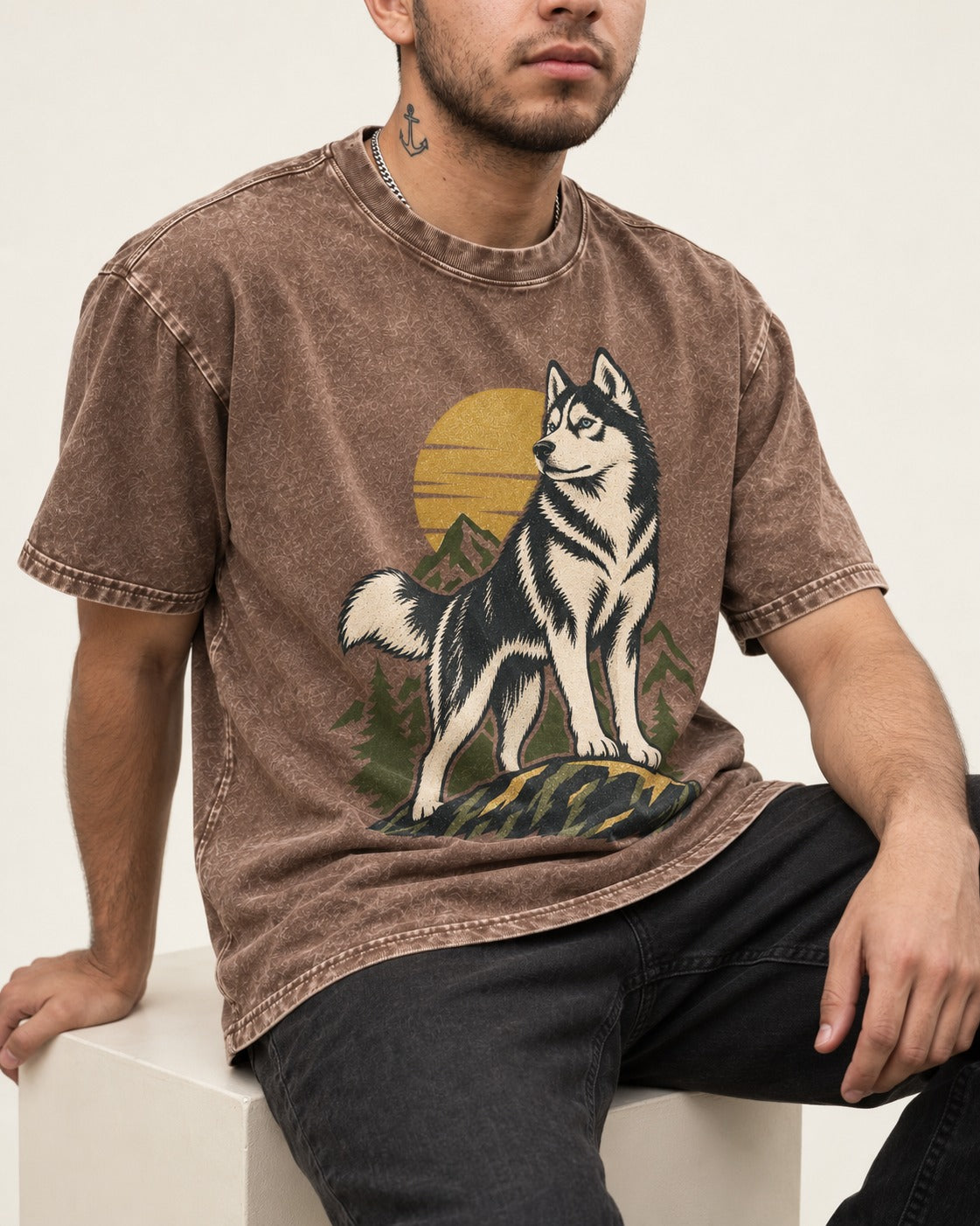 Husky Born to Roam Washed Tee in Coffee, worn by a seated model