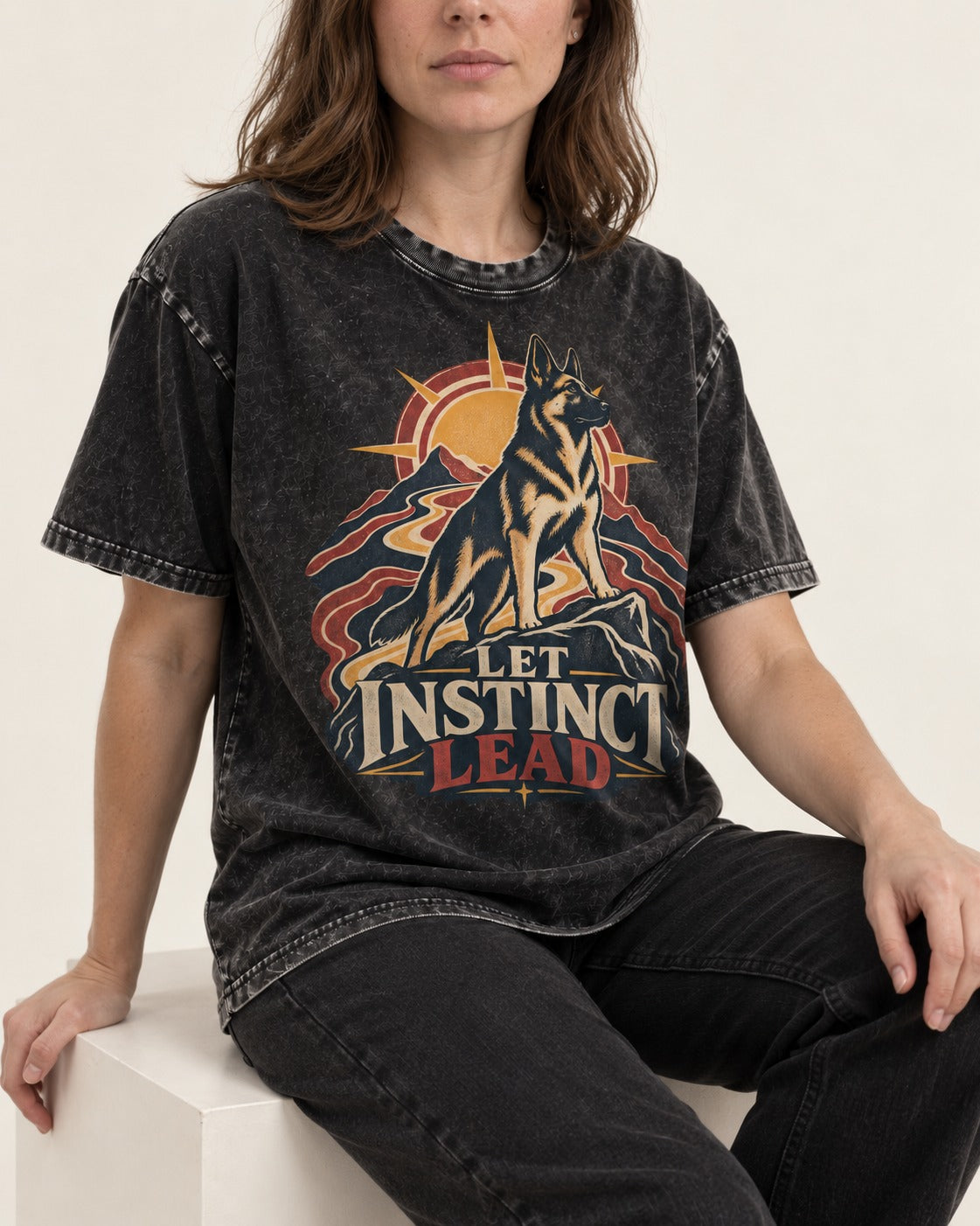 Let Instinct Lead Sunrise German Shepherd Dog Graphic Washed Tee in Black, worn by a seated model