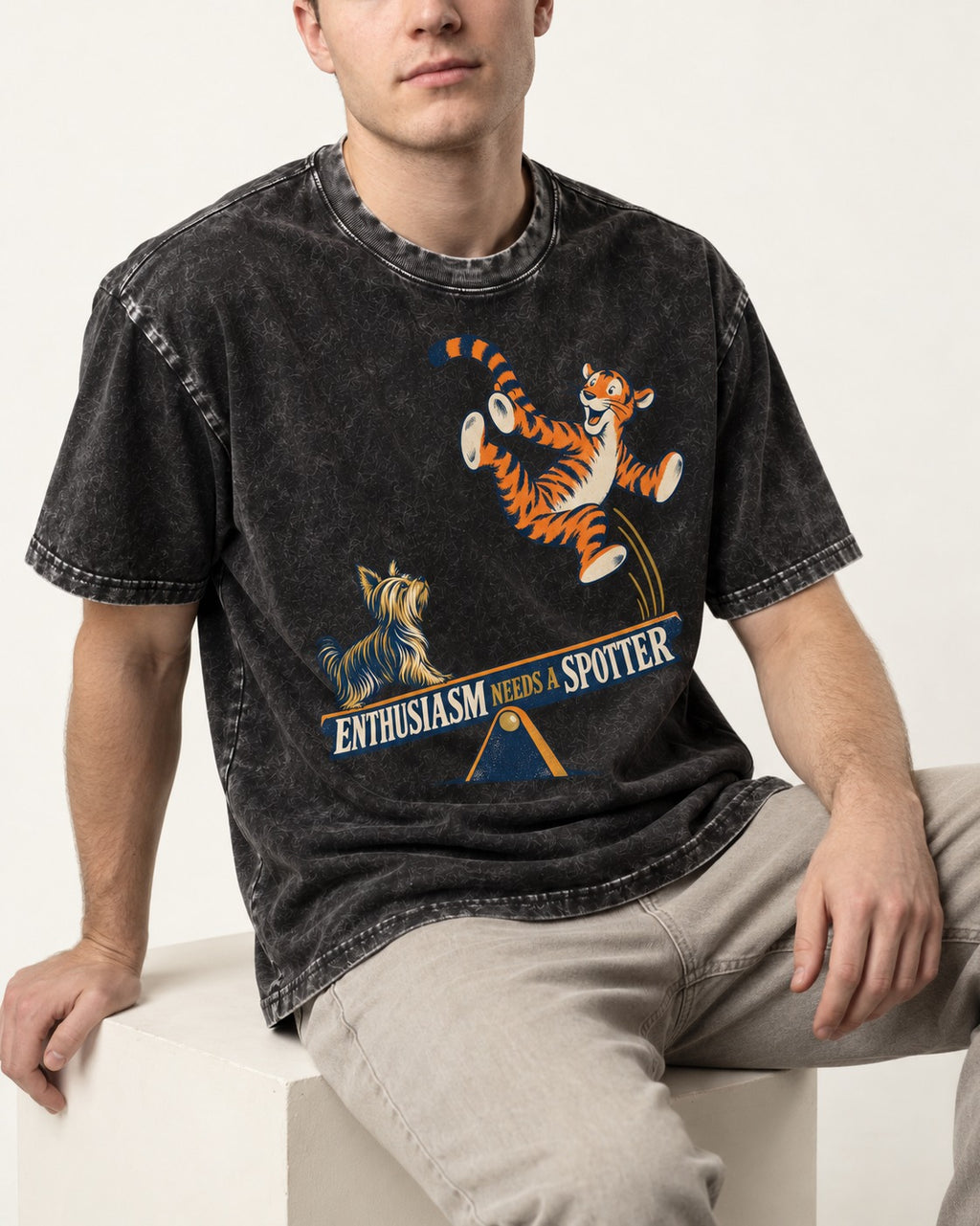 Yorkshire Terrier Enthusiasm Needs a Spotter Seesaw Graphic Washed Tee in Black, worn by a seated model