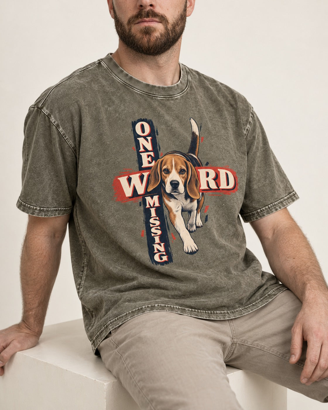 Beagle One Word Missing Washed Tee in Army Green, worn by a seated model