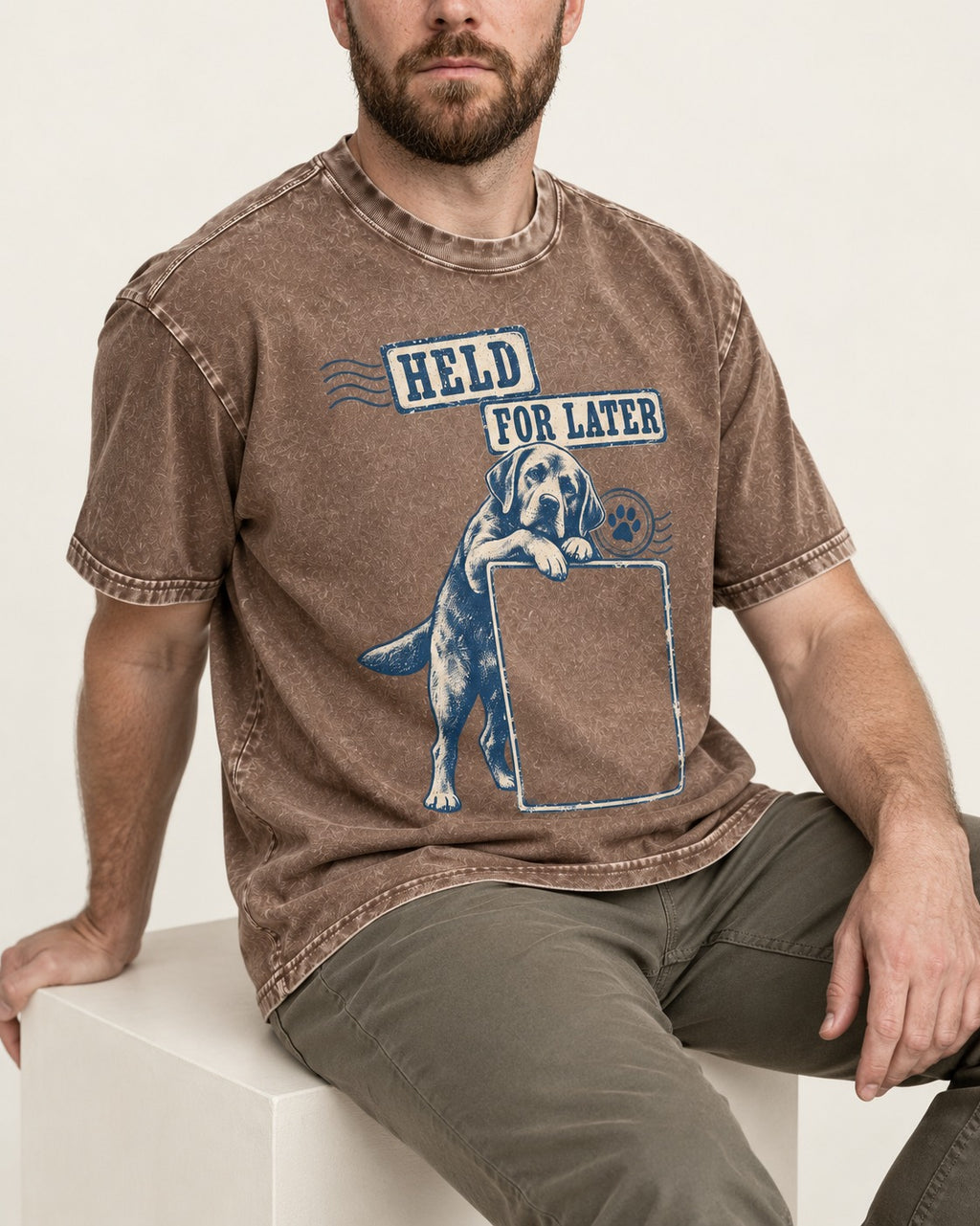 Held for Later Labrador Retriever Washed Tee in Coffee, worn by a seated model