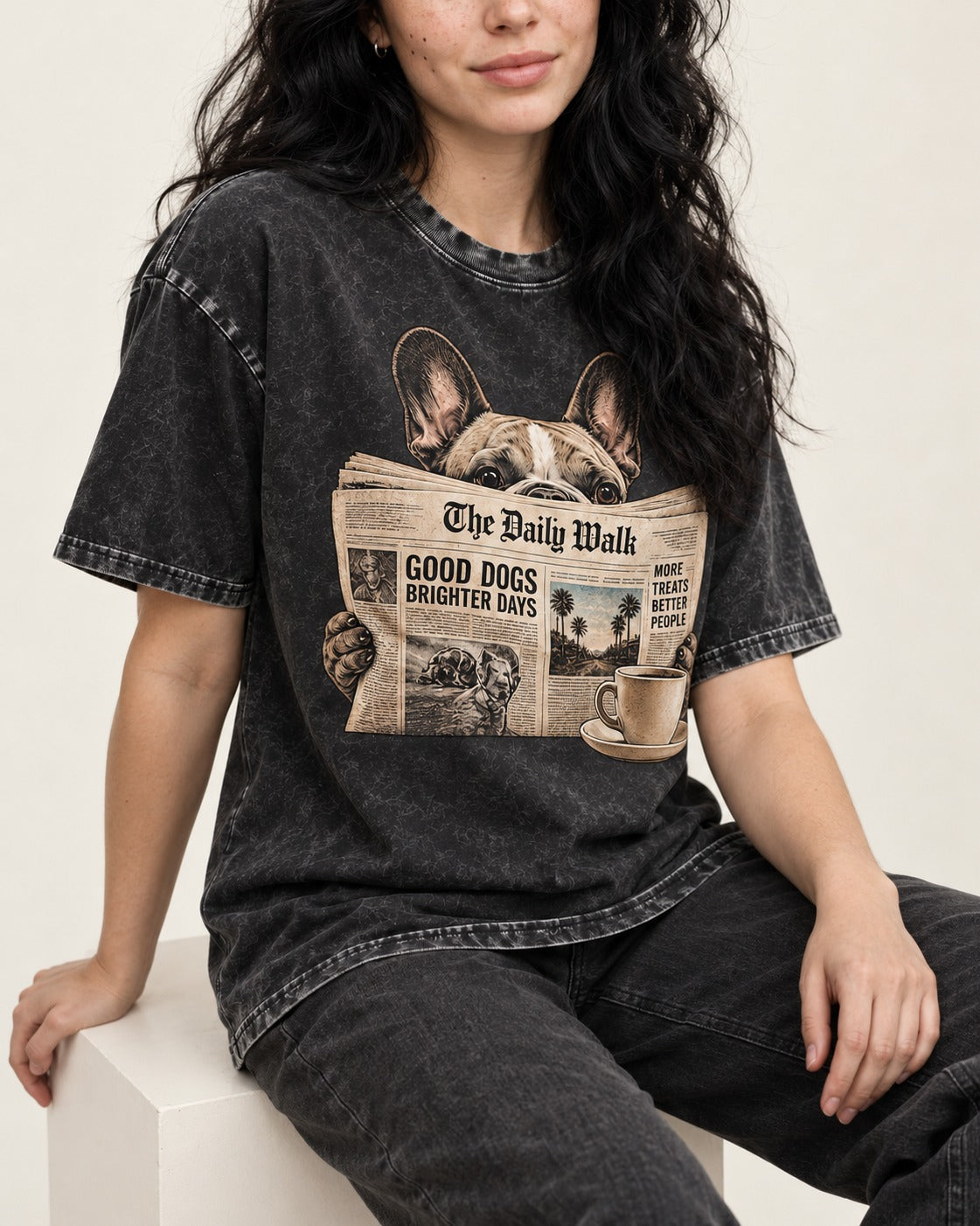 Frenchie Good Dogs Brighter Days Newspaper Graphic Washed Tee in Black, worn by a seated model