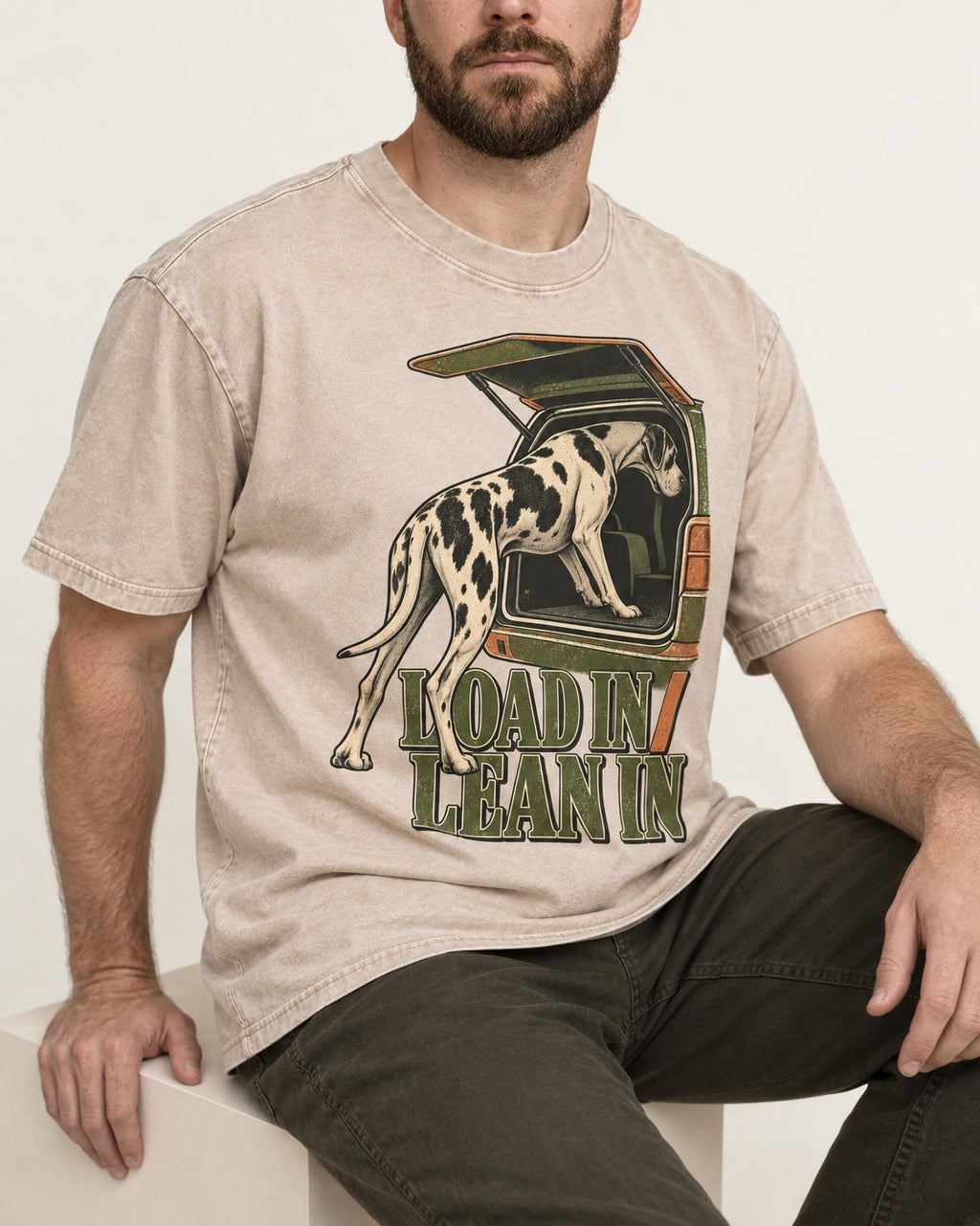Great Dane Loadin' Leanin' Washed Tee in Apricot, worn by a seated model