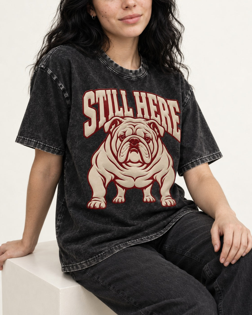 English Bulldog Still Here Collegiate Graphic Washed Tee in Black, worn by a seated model