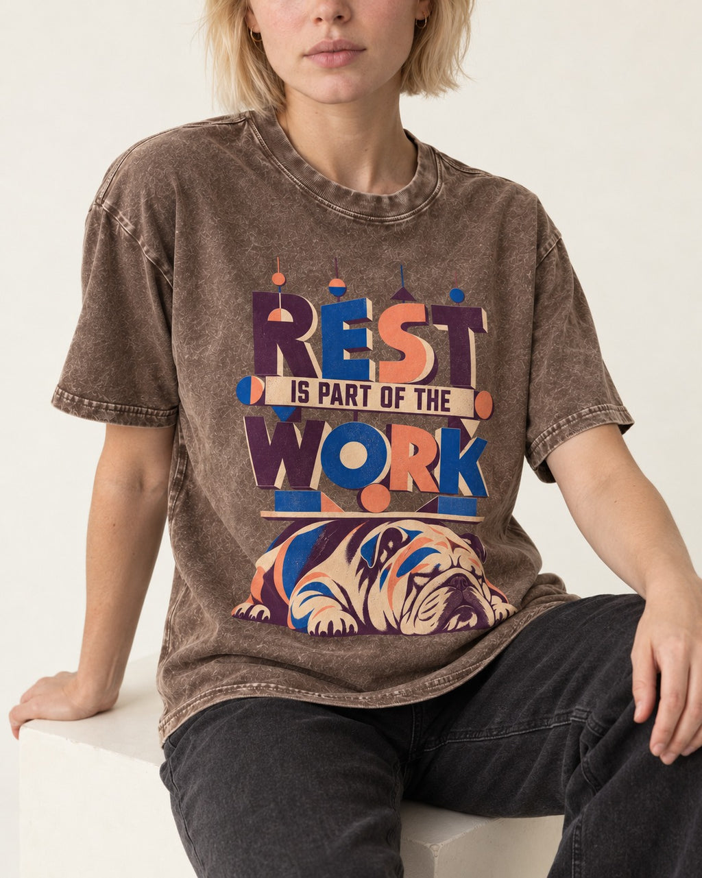 Rest Is Work English Bulldog Washed Tee in Coffee, worn by a seated model