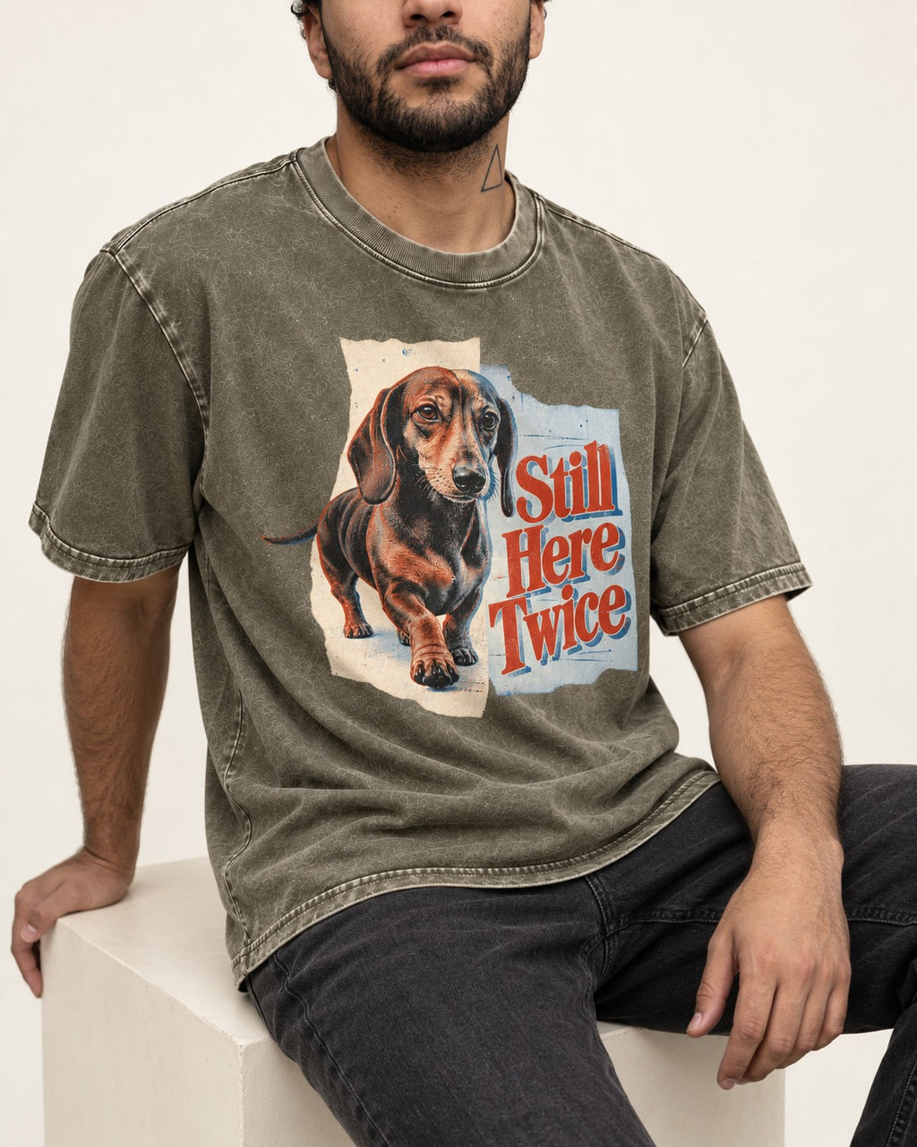 Dachshund Still Here Twice Torn Paper Graphic Washed Tee in Army Green, worn by a seated model