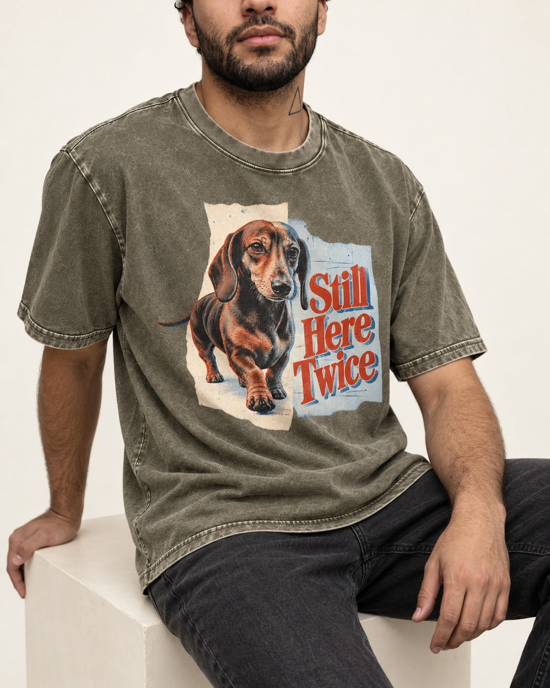 Dachshund Still Here Twice Torn Paper Graphic Washed Tee in Army Green, worn by a seated model