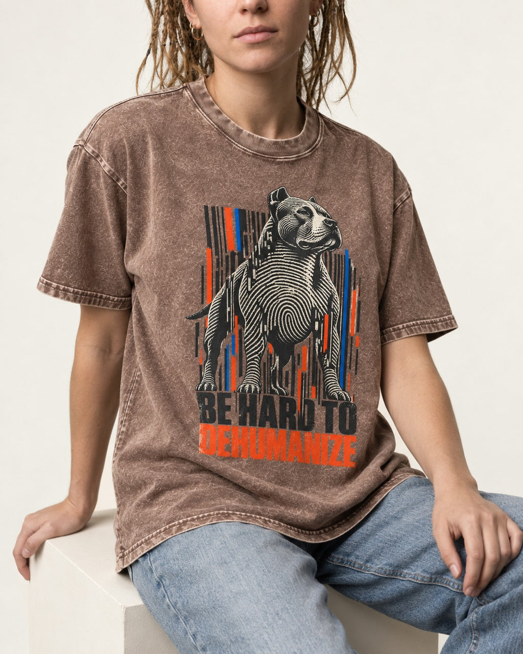 Pitbull Hard to Dehumanize Washed Tee in Coffee, worn by a seated model