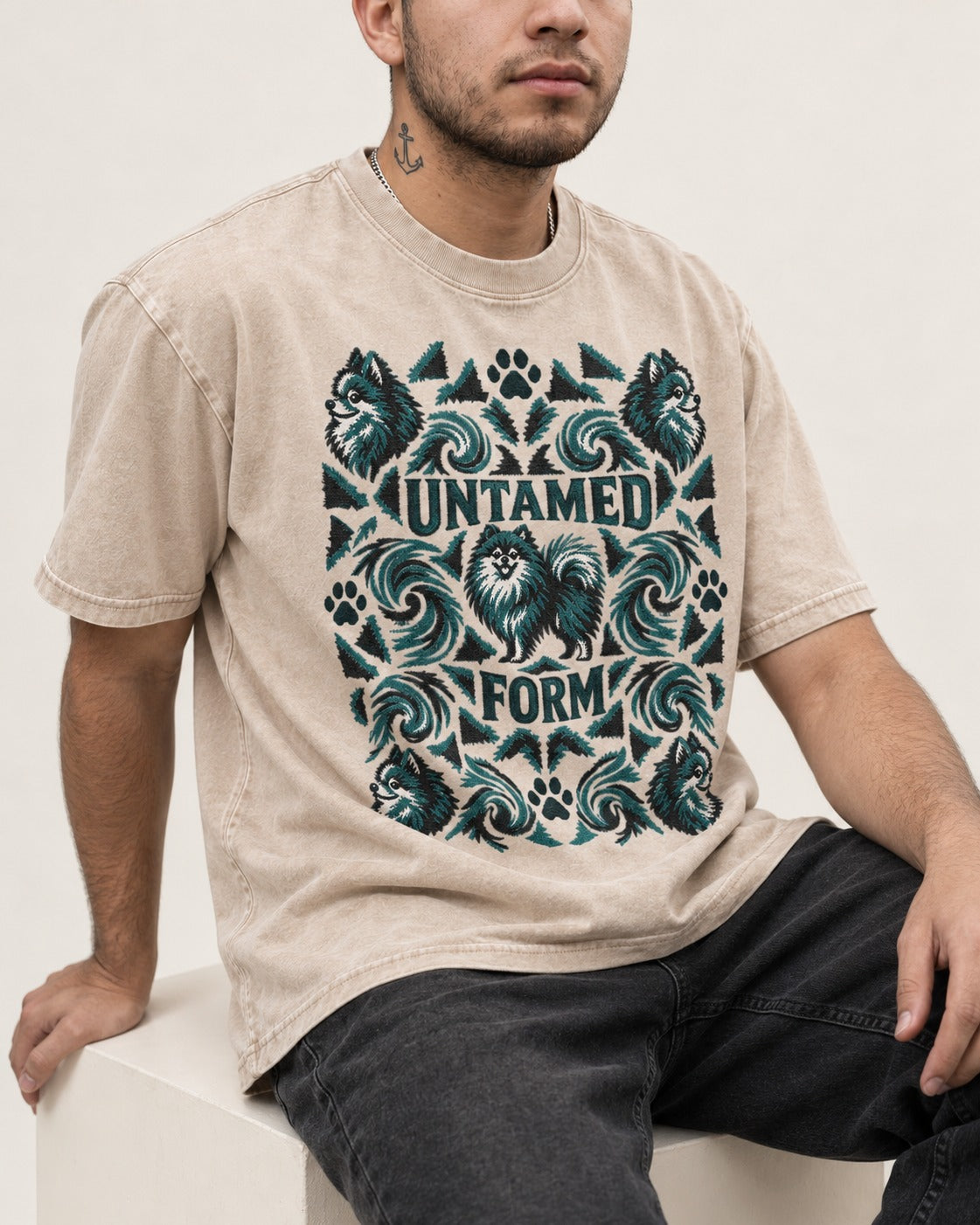 Pomeranian Untamed Form Washed Tee in Apricot, worn by a seated model