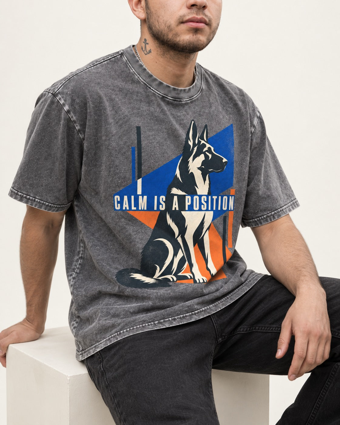 Calm Is A Position Geometric German Shepherd Dog Graphic Washed Tee in Gray, worn by a seated model