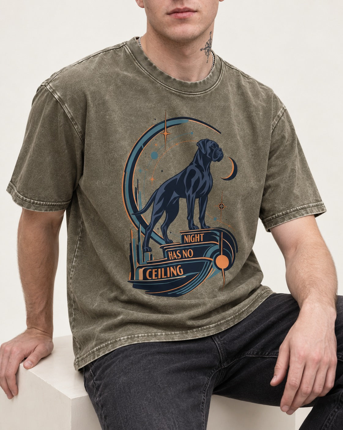 Night Has No Ceiling Boxer Cosmic Graphic Washed Tee in Army Green, worn by a seated model
