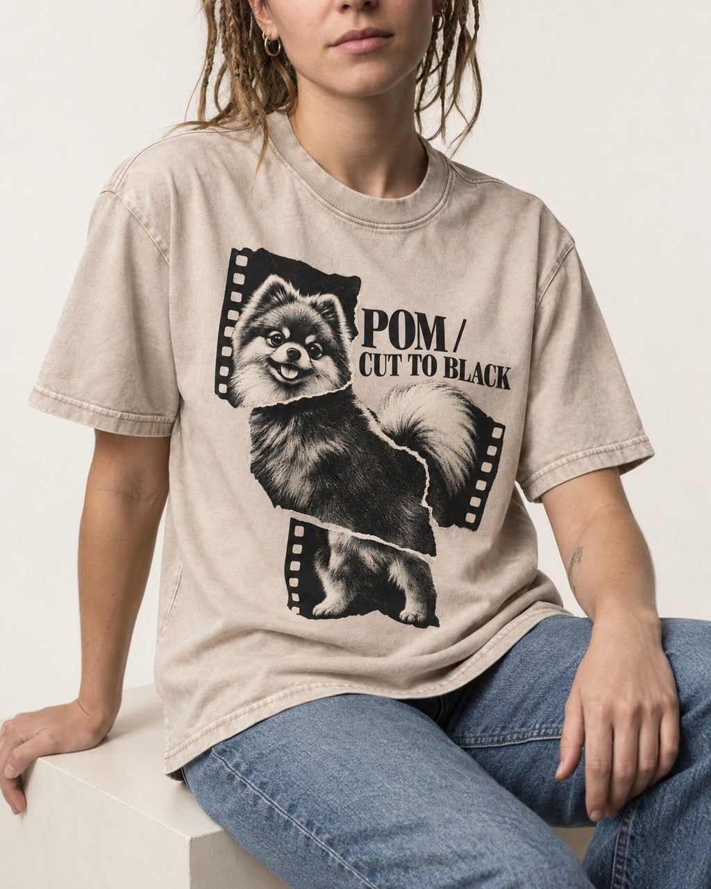 Pomeranian Cut to Black Washed Tee in Apricot, worn by a seated model