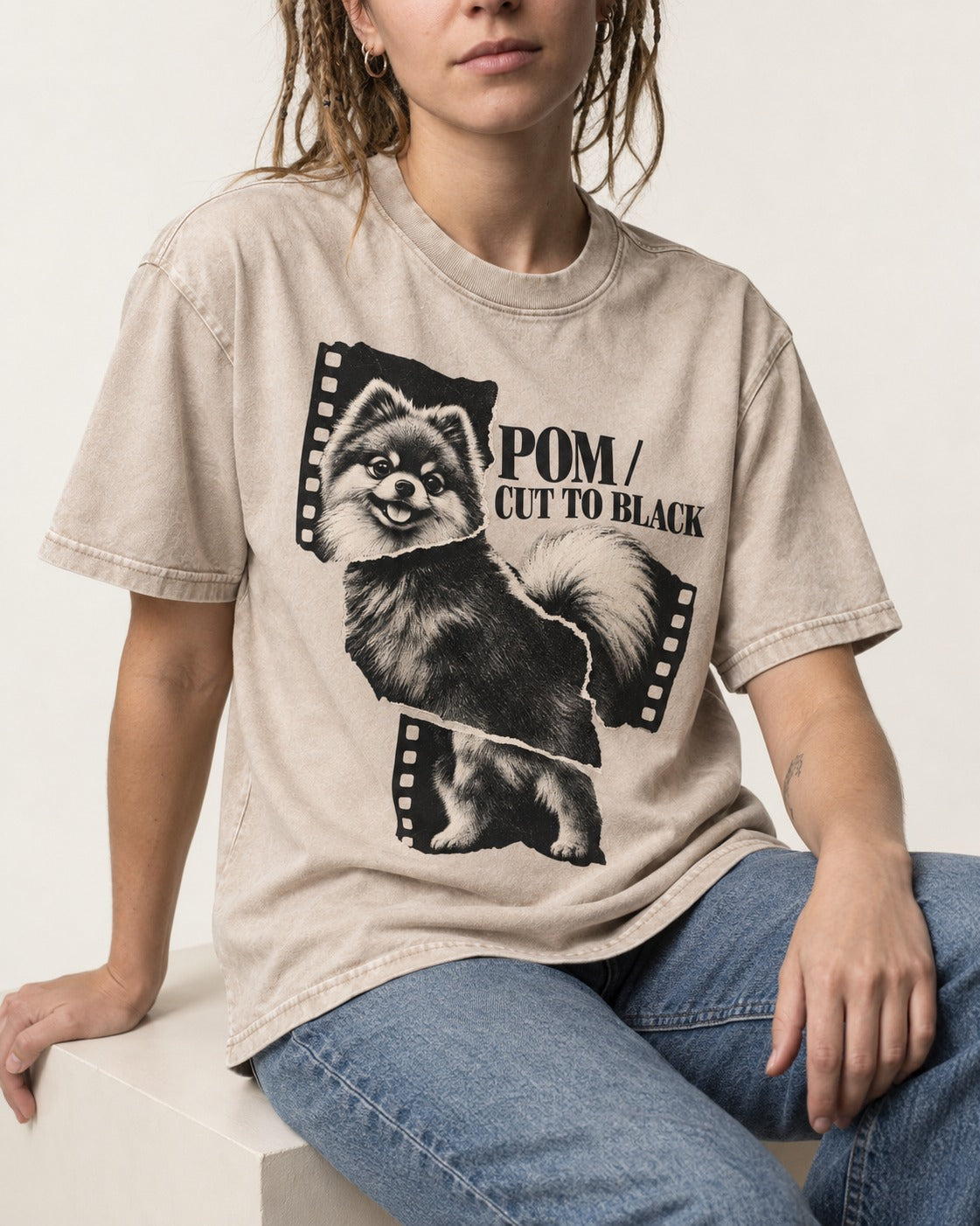 Pomeranian Cut to Black Washed Tee in Apricot, worn by a seated model