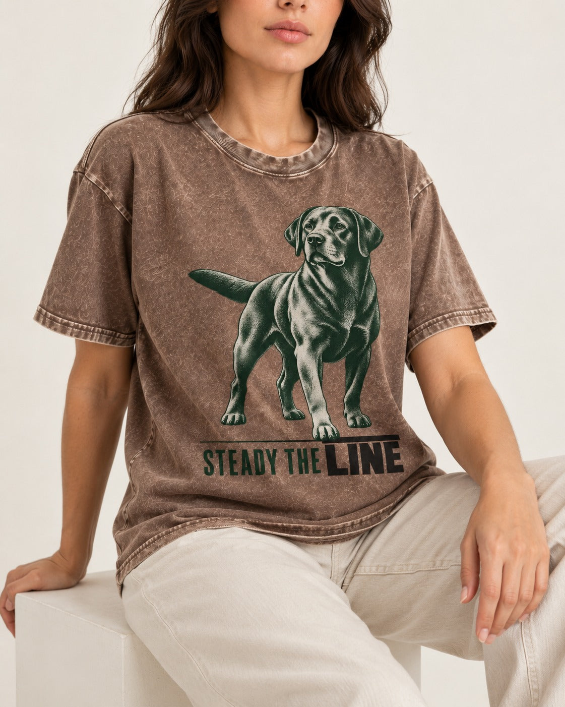 Steady the Line Labrador Retriever Washed Tee in Coffee, worn by a seated model