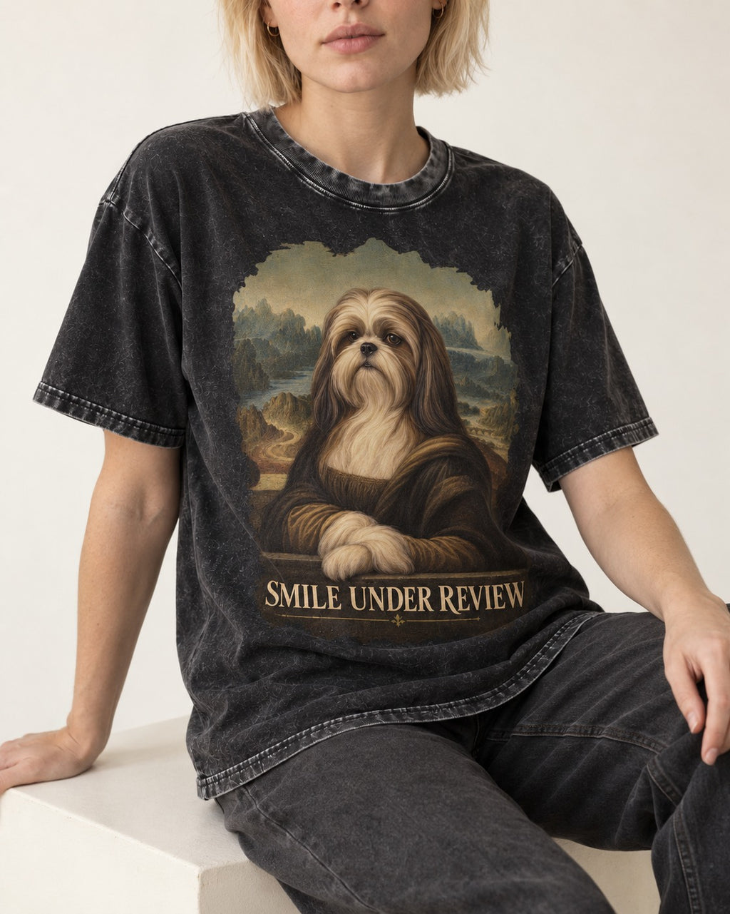 Shih Tzu Smile Under Review Old Master Portrait Graphic Washed Tee in Black, worn by a seated model