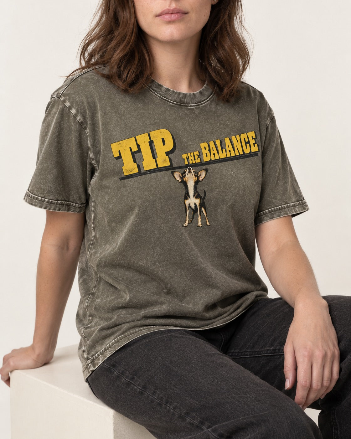 Chihuahua Tip the Balance Beam Graphic Washed Tee in Army Green, worn by a seated model