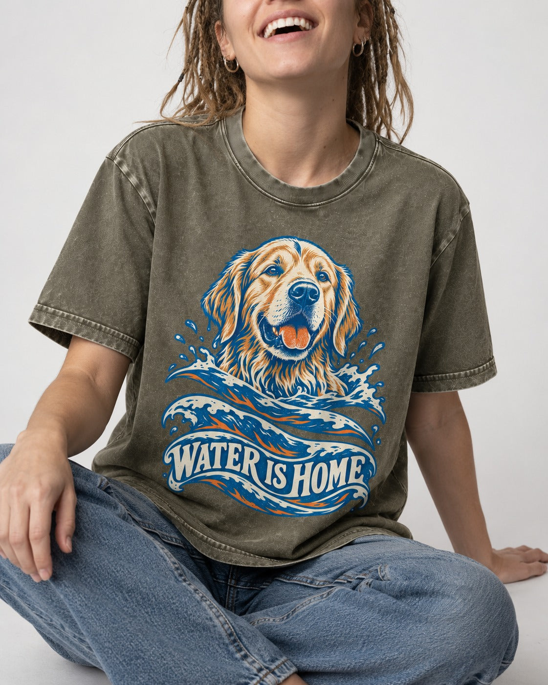 Golden Retriever Water Is Home Ocean Wave Graphic Washed Tee in Army Green, worn by a seated model