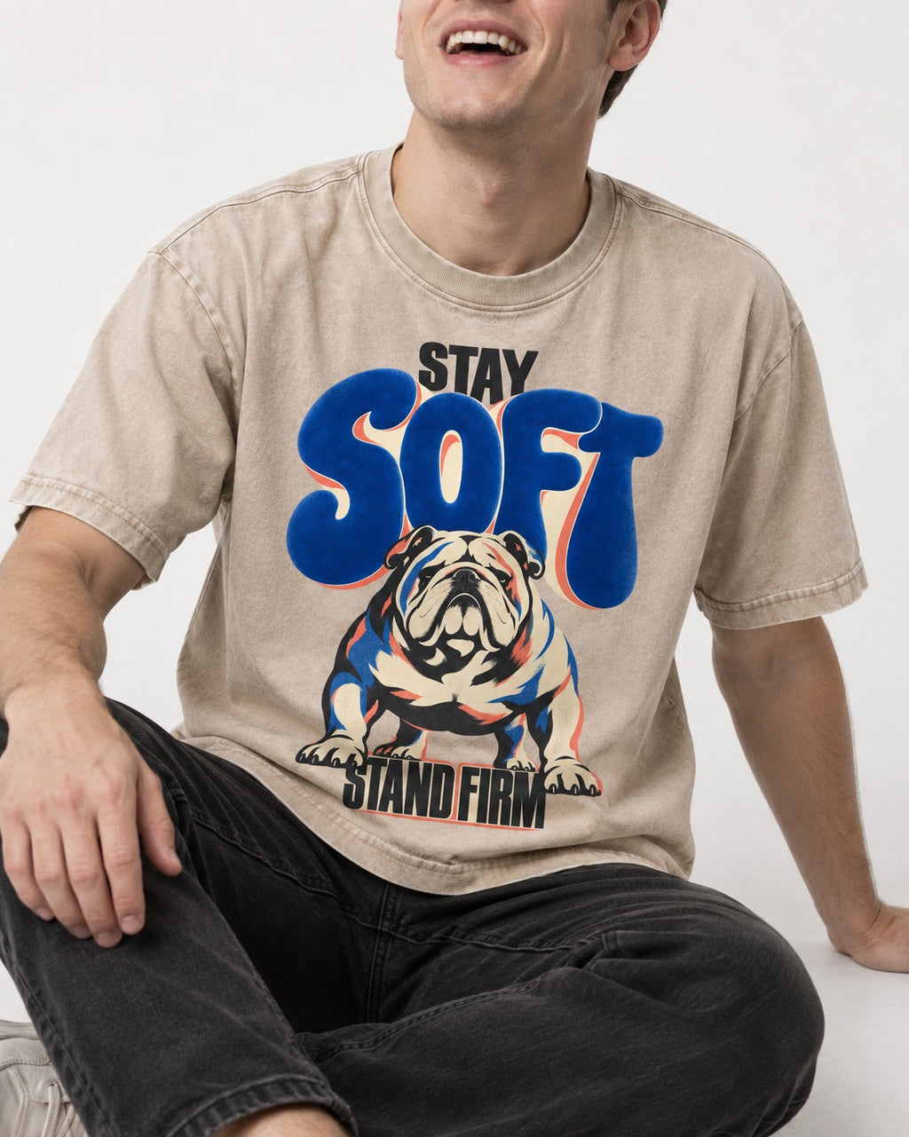 Stay Soft Stand Firm English Bulldog Washed Tee in Apricot, worn by a seated model