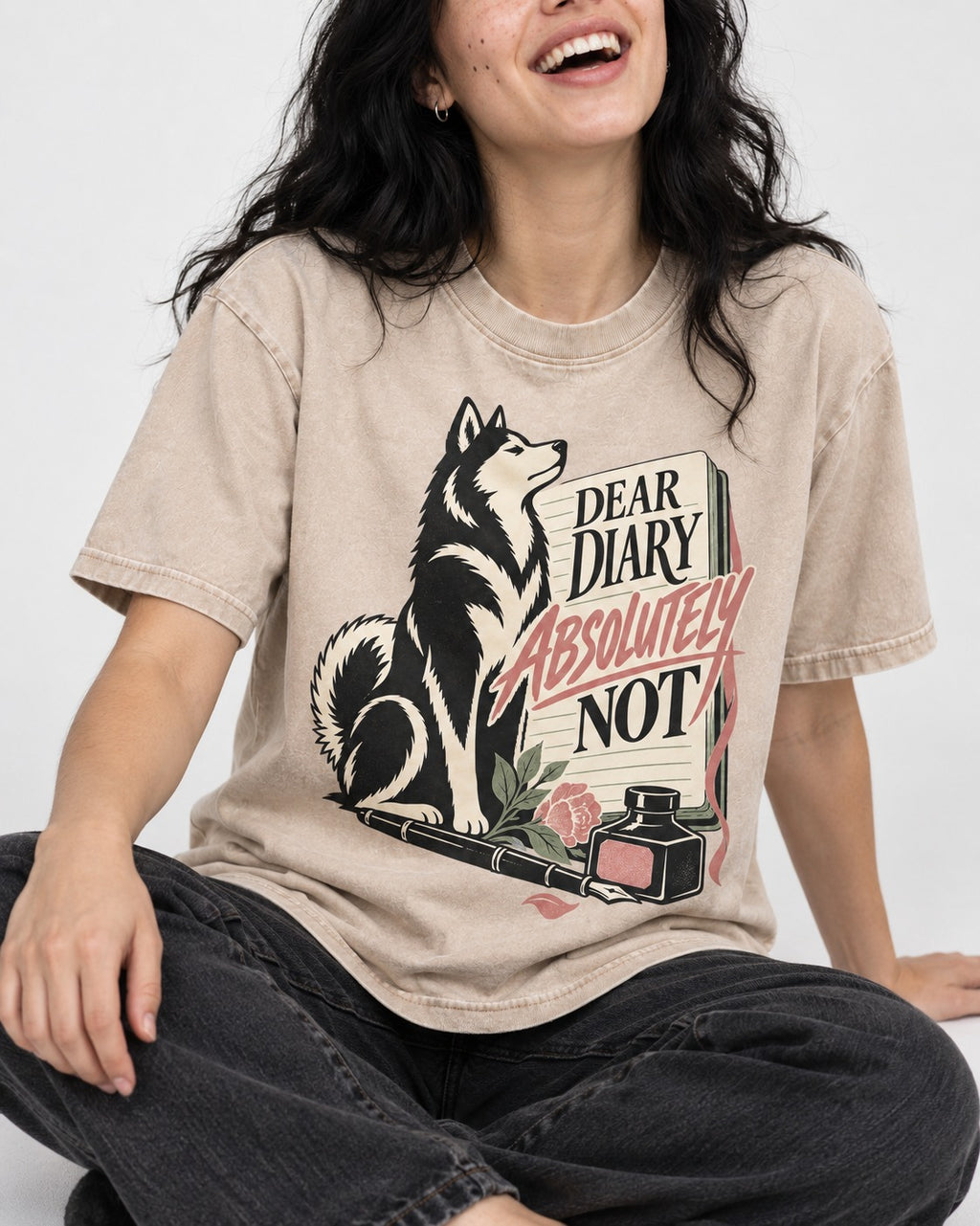 Husky Absolutely Not Washed Tee in Apricot, worn by a seated model