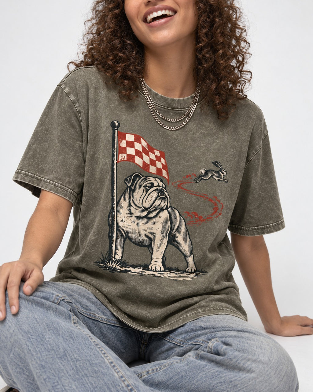 English Bulldog Checkered Flag Rabbit Chase Washed Tee in Army Green, worn by a seated model