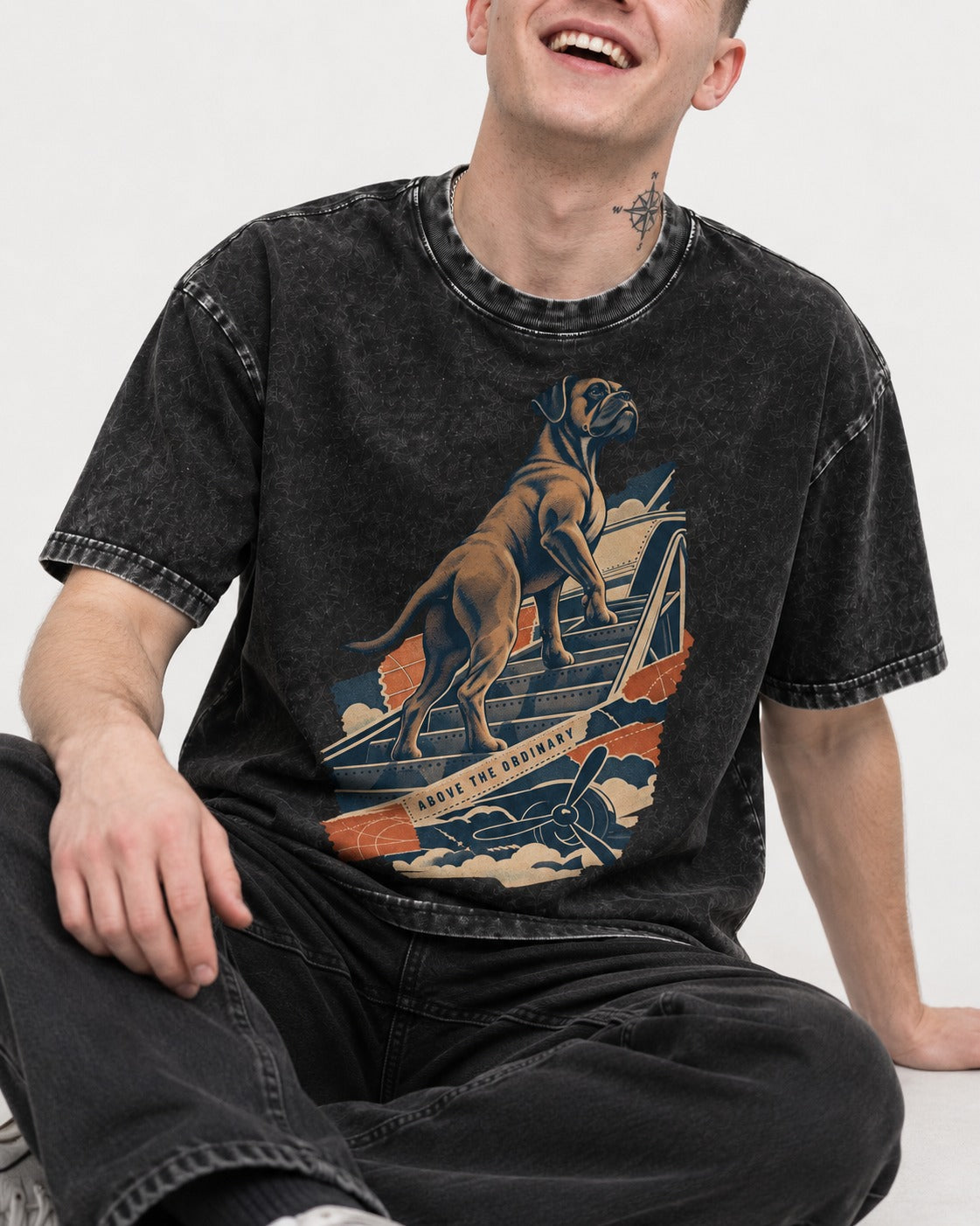 Above the Ordinary Boxer Aviation Graphic Washed Tee in Black, worn by a seated model
