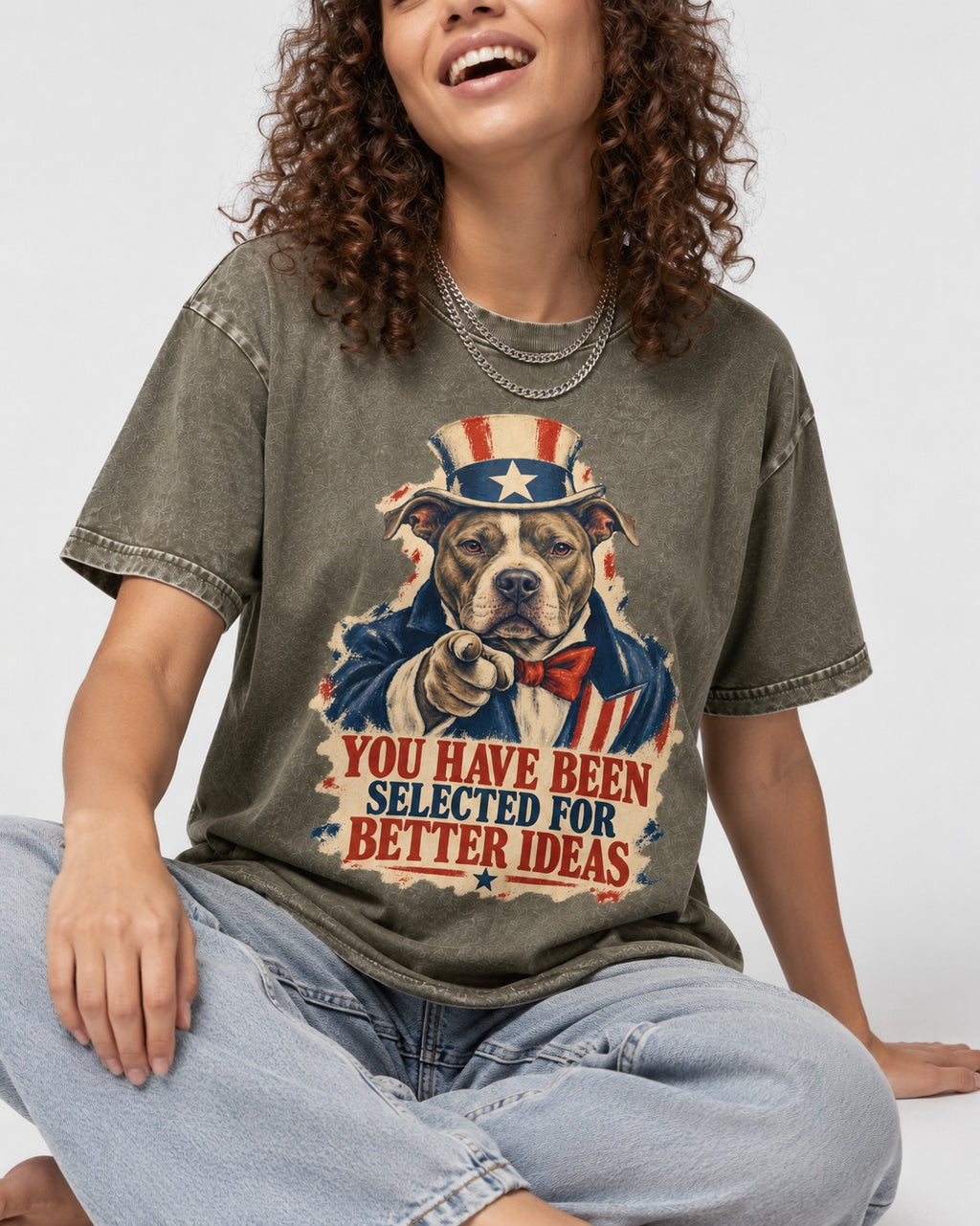 Pitbull You Have Been Selected for Better Ideas Uncle Sam Graphic Washed Tee in Army Green, worn by a seated model