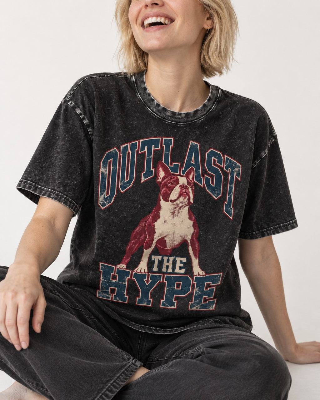 Boston Terrier Outlast The Hype Collegiate Graphic Washed Tee in Black, worn by a seated model