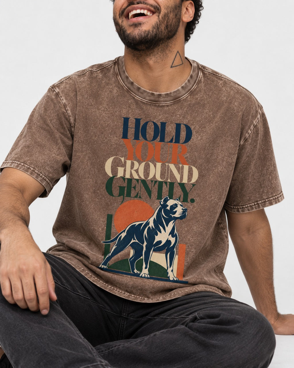 Pitbull Hold Your Ground Gently Standing Dog Graphic Washed Tee in Coffee, worn by a seated model