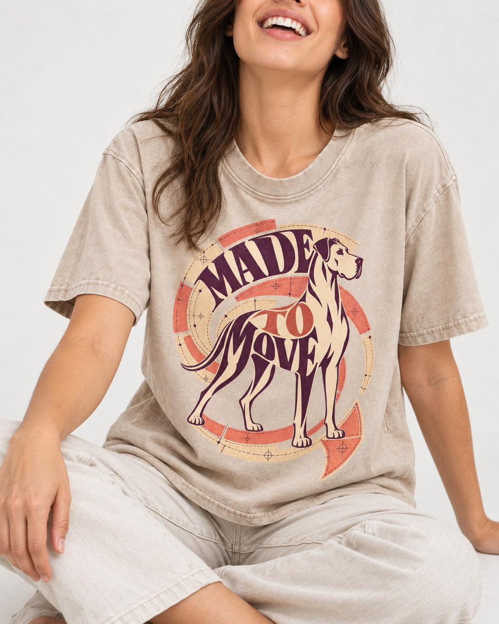 Great Dane Made to Move Washed Tee in Apricot, worn by a seated model