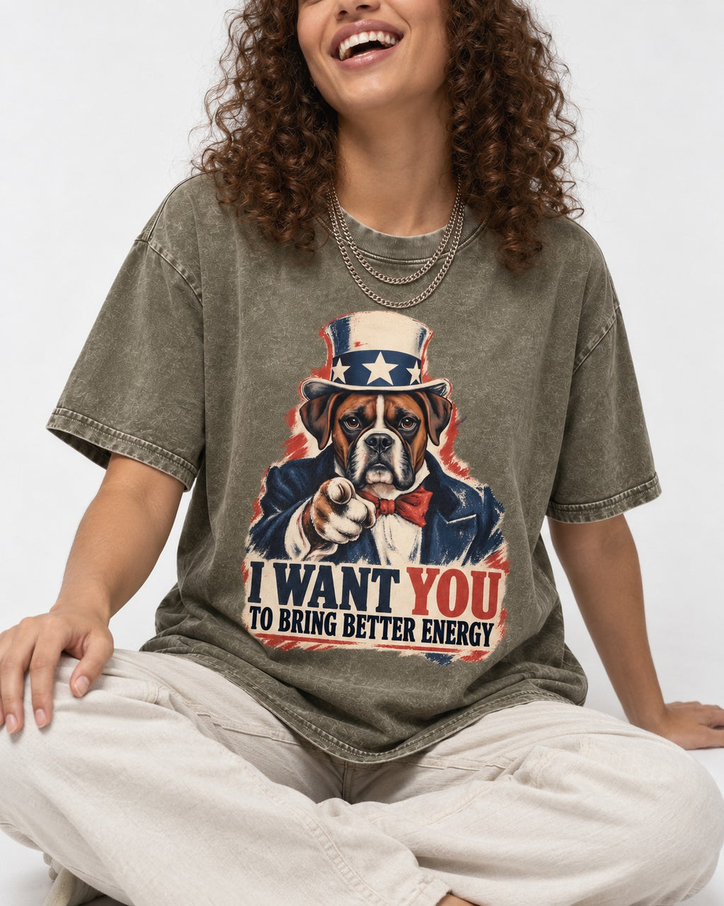 I Want You to Bring Better Energy Boxer Recruitment Poster Graphic Washed Tee in Army Green, worn by a seated model