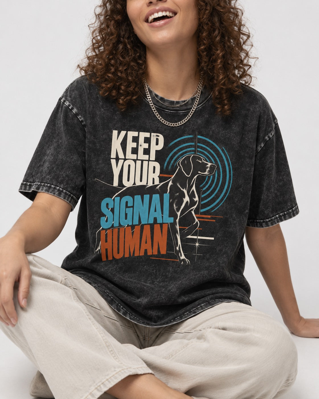 German Shorthaired Pointer Keep Your Signal Human Broadcast Graphic Washed Tee in Black, worn by a seated model