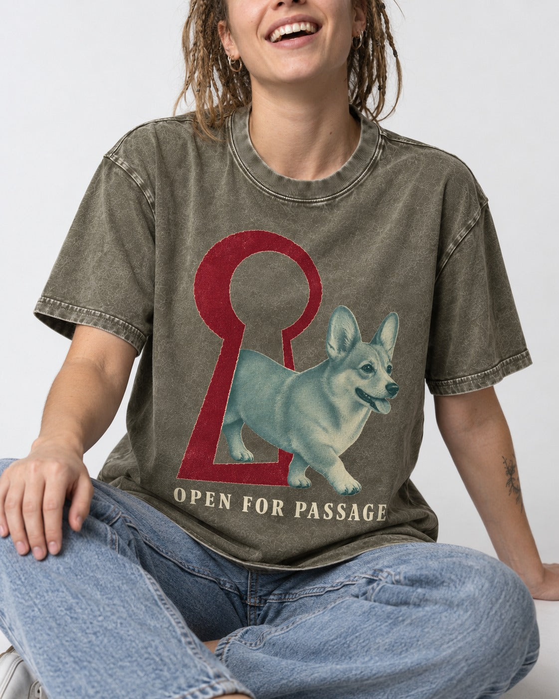 Corgi Open for Passage Keyhole Graphic Washed Tee in Army Green, worn by a seated model