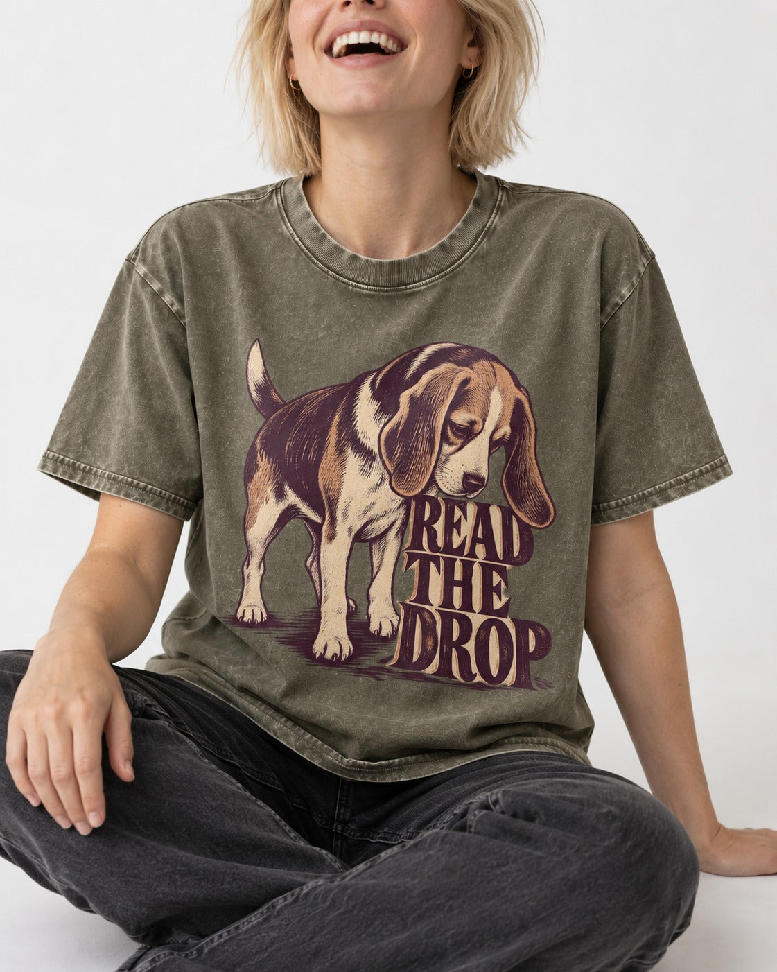 Beagle Read The Drop Washed Tee in Army Green, worn by a seated model