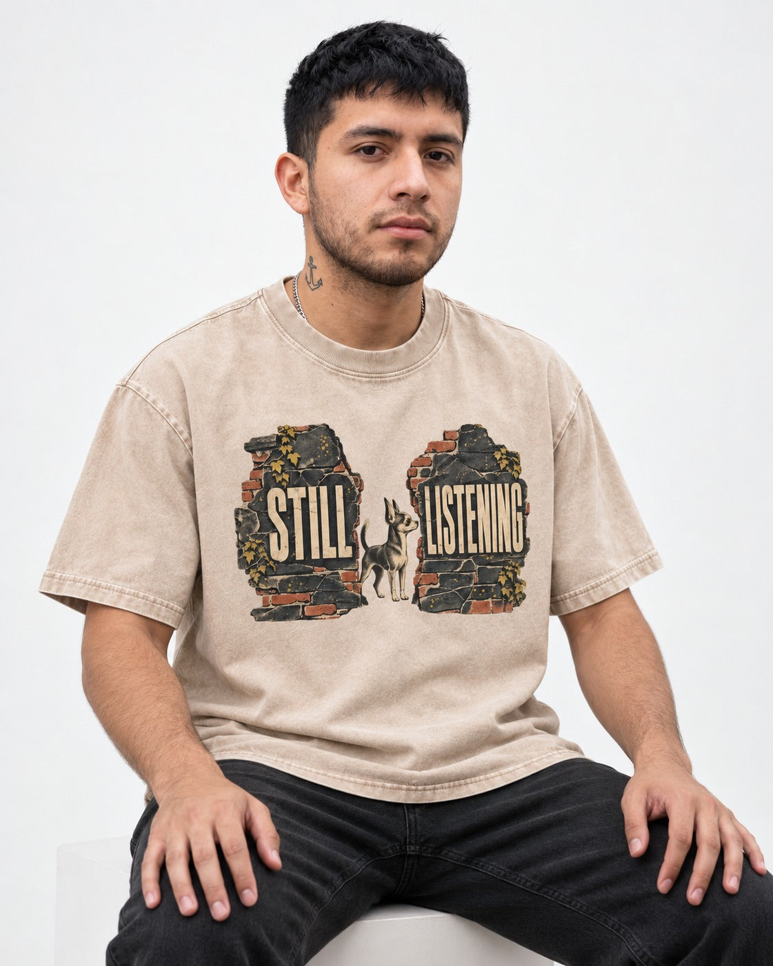 Chihuahua Still Listening Washed Tee in Apricot, worn by a seated model