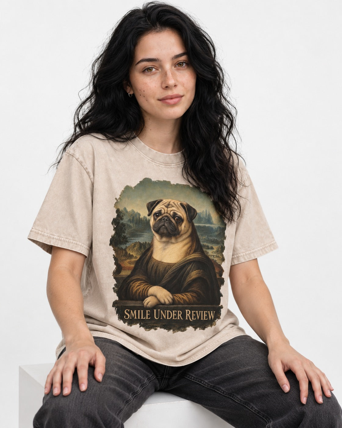 Pug Smile Under Review Mona Lisa Graphic Washed Tee in Apricot, worn by a seated model