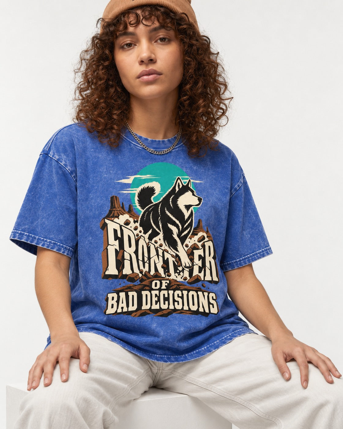 Husky Frontier of Bad Decisions Desert Graphic Washed Tee in Royal Blue, worn by a seated model
