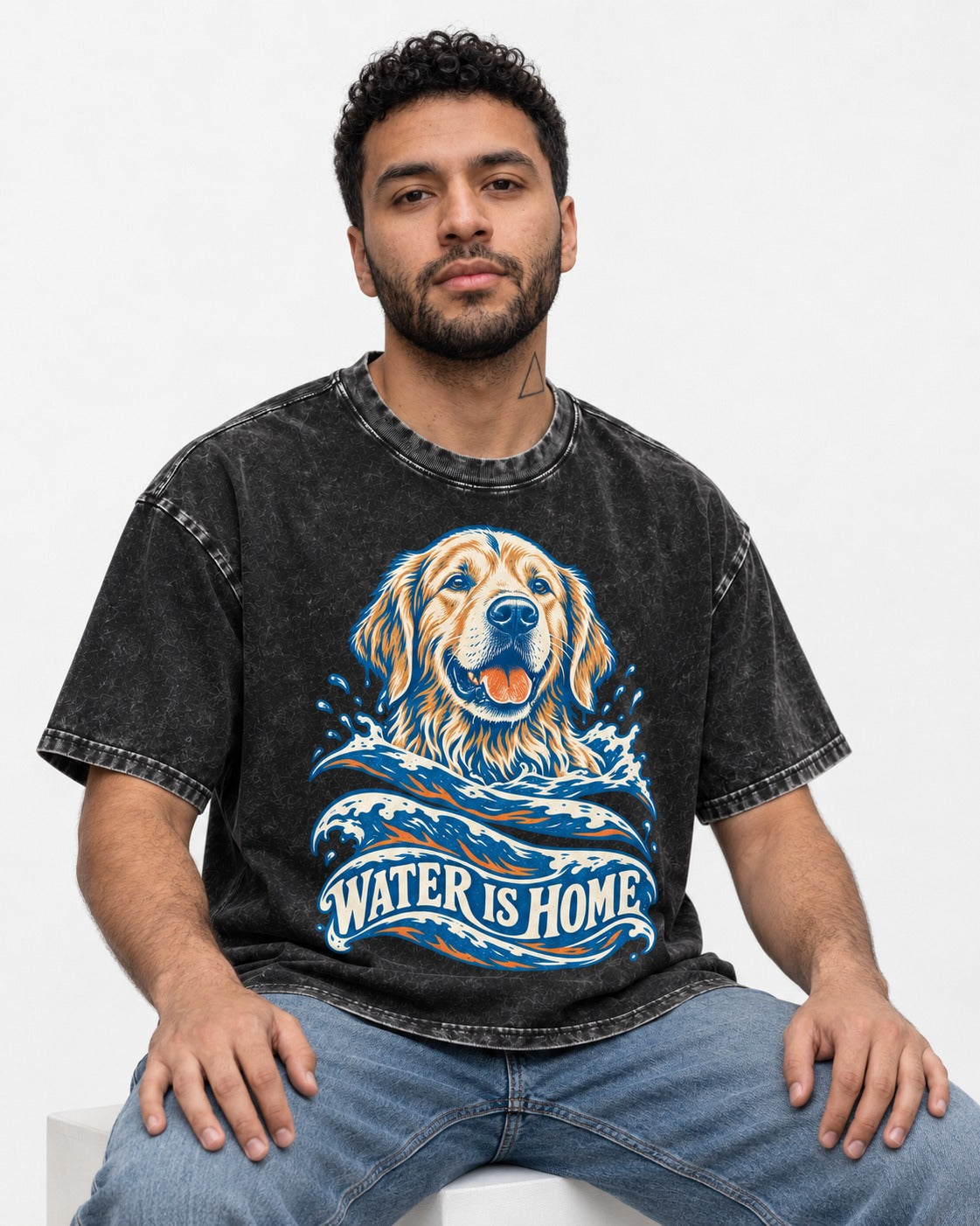 Golden Retriever Water Is Home Ocean Wave Graphic Washed Tee in Black, worn by a seated model