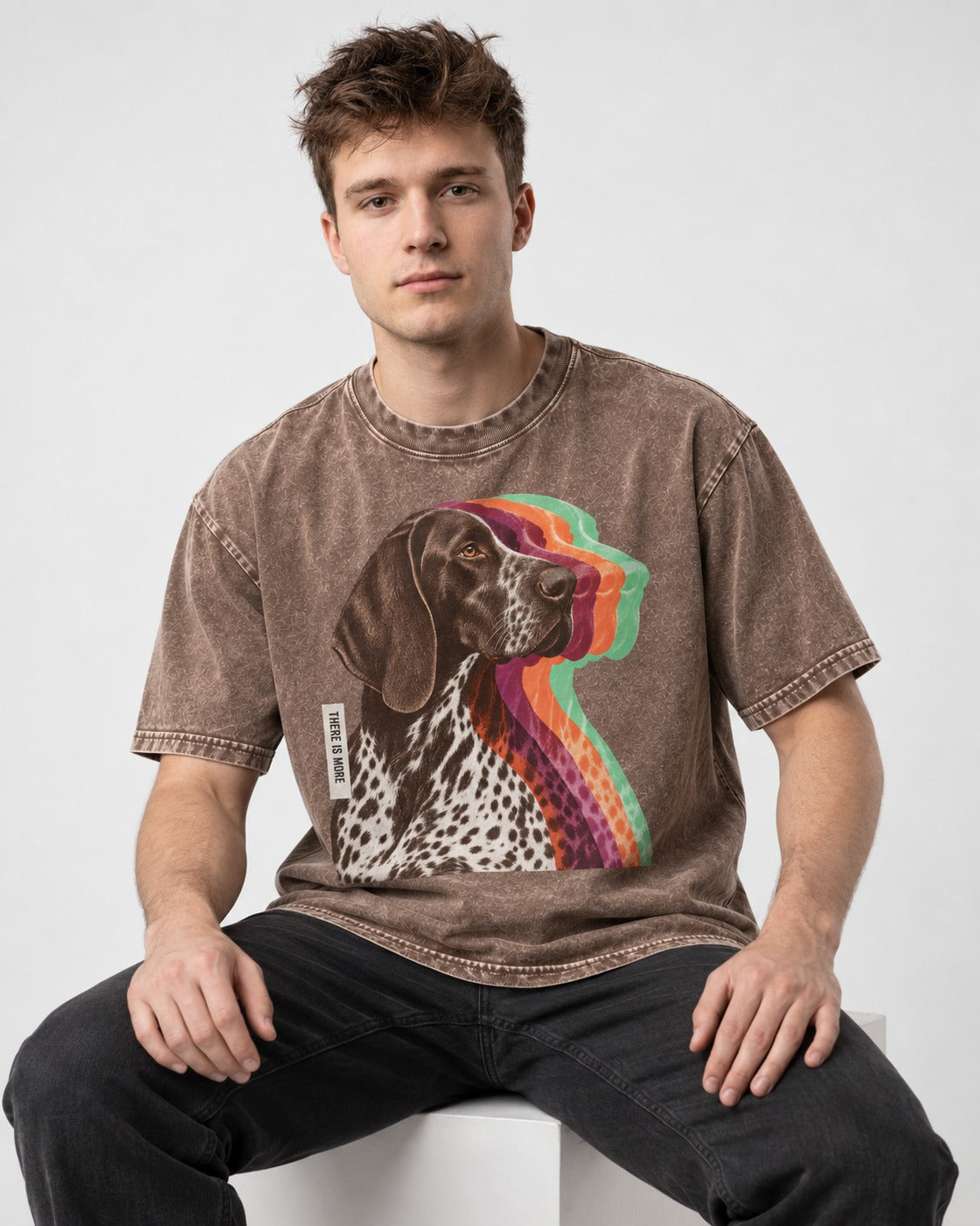 There Is More German Shorthaired Pointer Washed Tee in Coffee, worn by a seated model