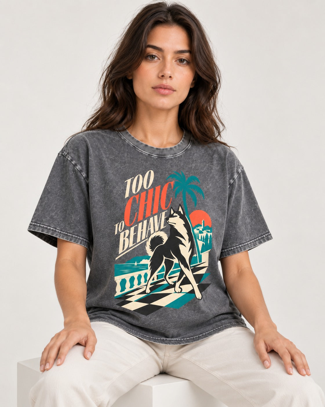 Husky Too Chic to Behave Riviera Graphic Washed Tee in Gray, worn by a seated model