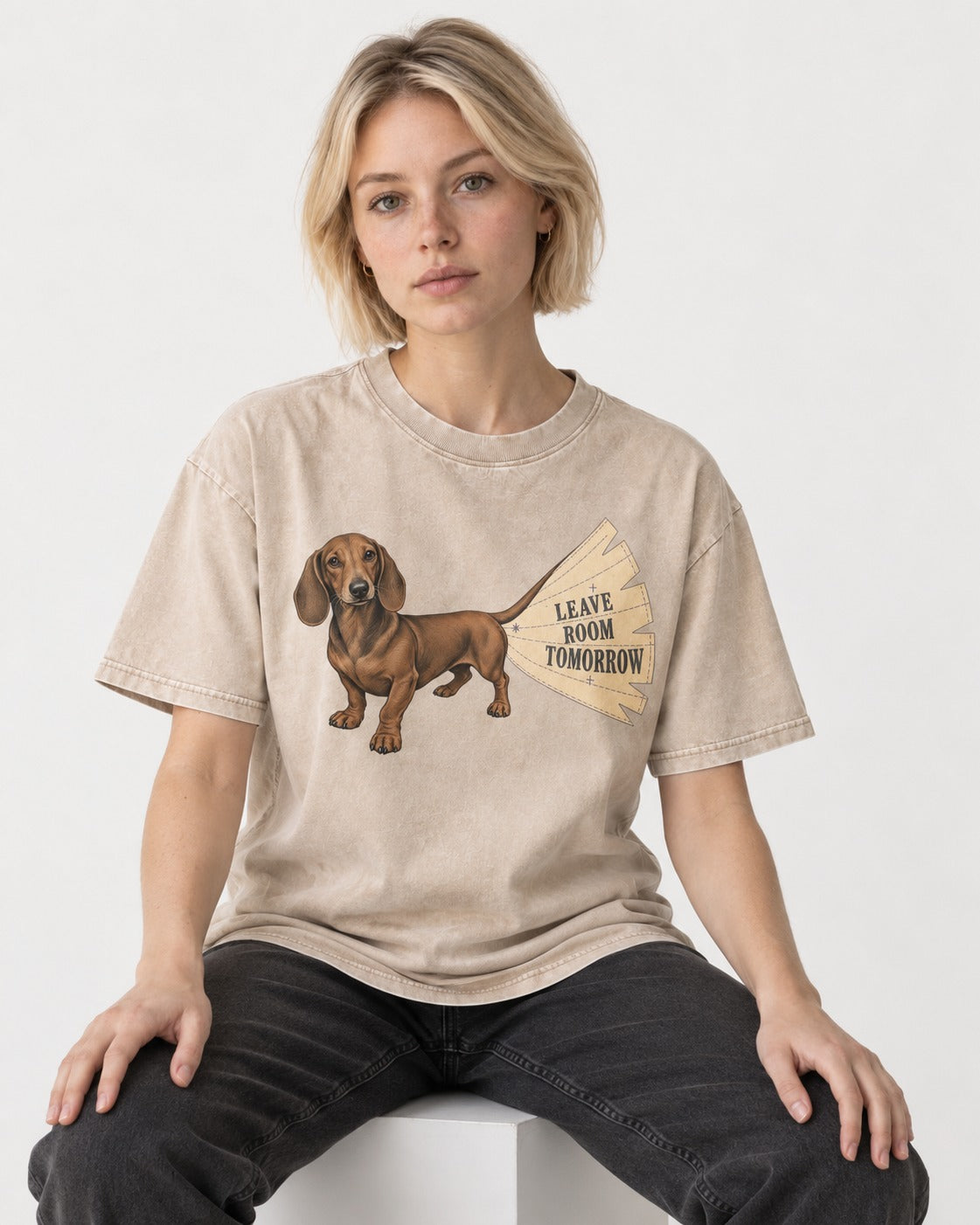 Dachshund Leave Room Tomorrow Washed Tee in Apricot, worn by a seated model