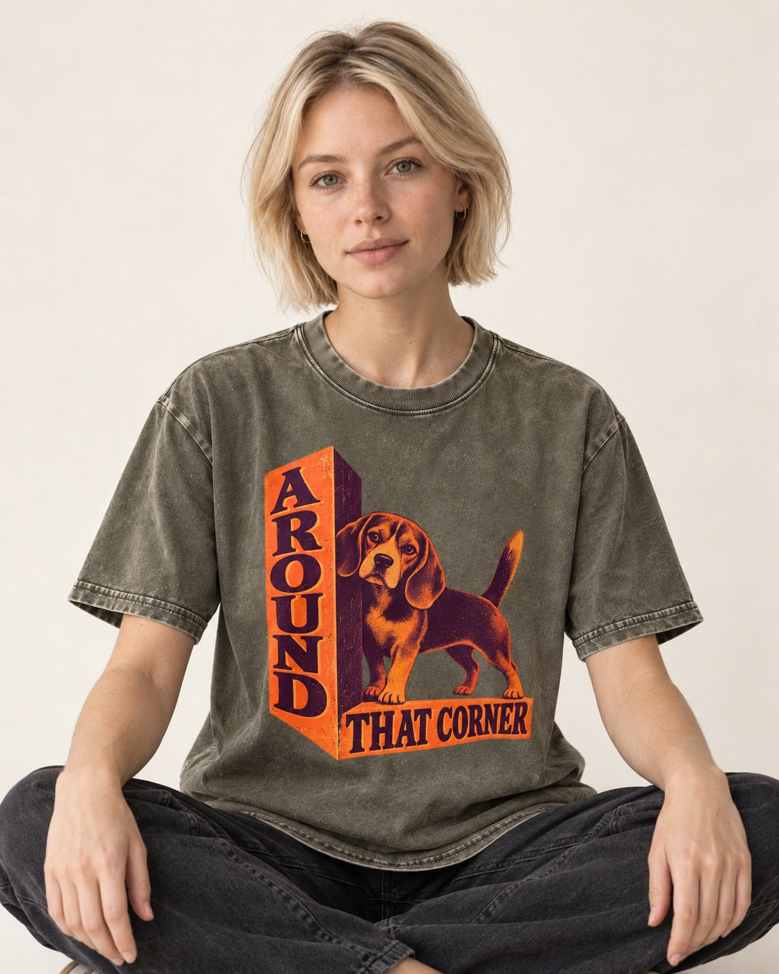 Beagle Around That Corner Graphic Washed Tee in Army Green, worn by a seated model