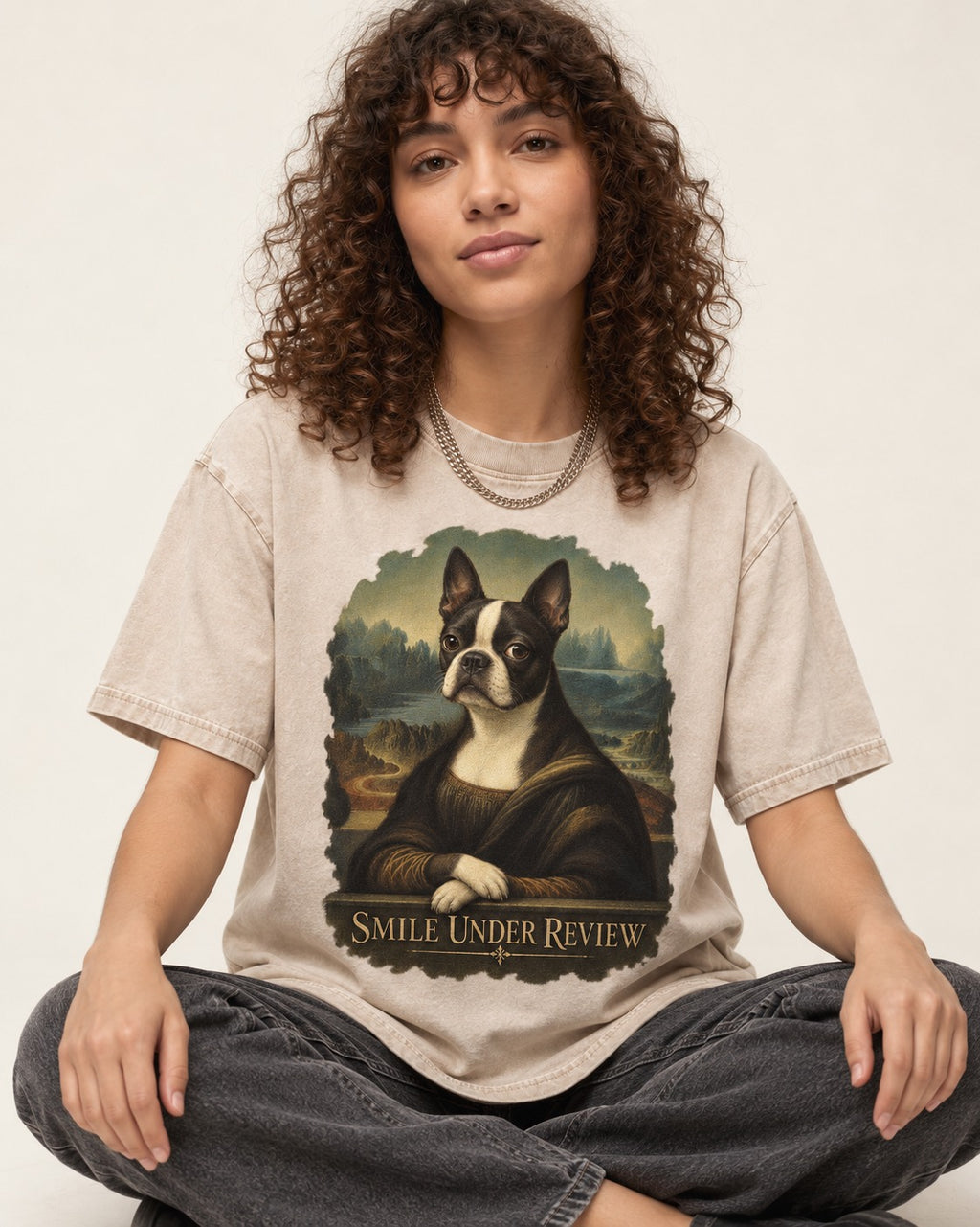 Smile Under Review Boston Terrier Mona Lisa Portrait Washed Tee in Apricot, worn by a seated model