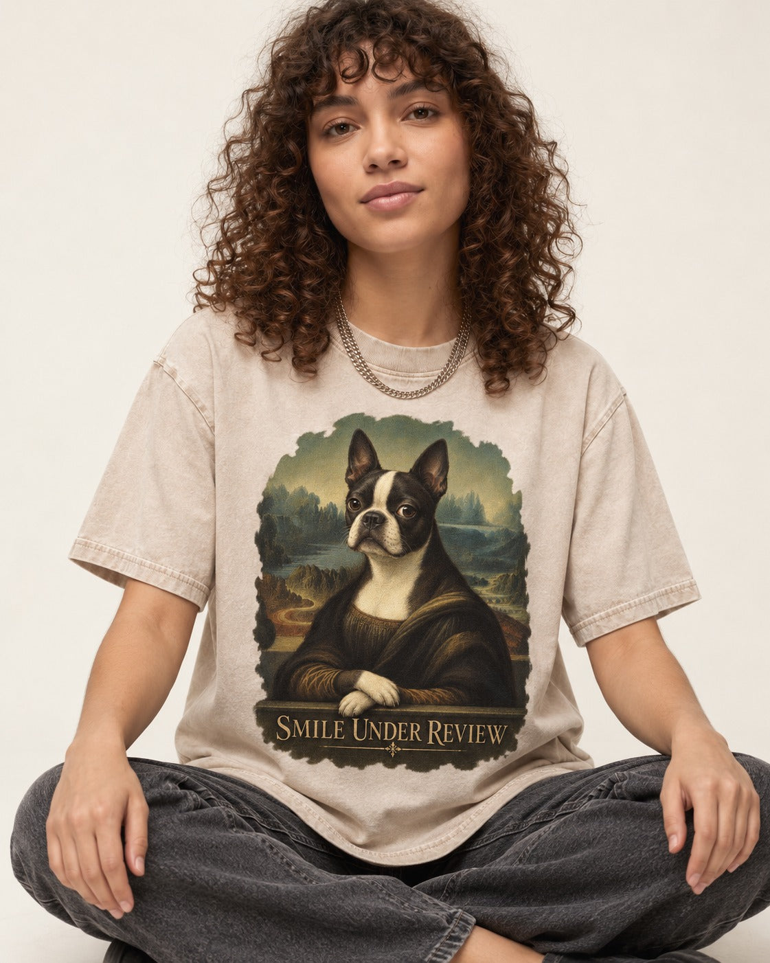 Smile Under Review Boston Terrier Mona Lisa Portrait Washed Tee in Apricot, worn by a seated model