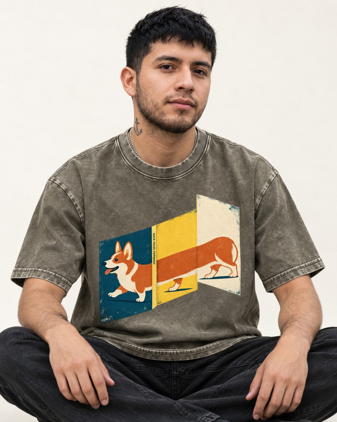 Corgi Back Folds Forward Panels Washed Tee in Army Green, worn by a seated model