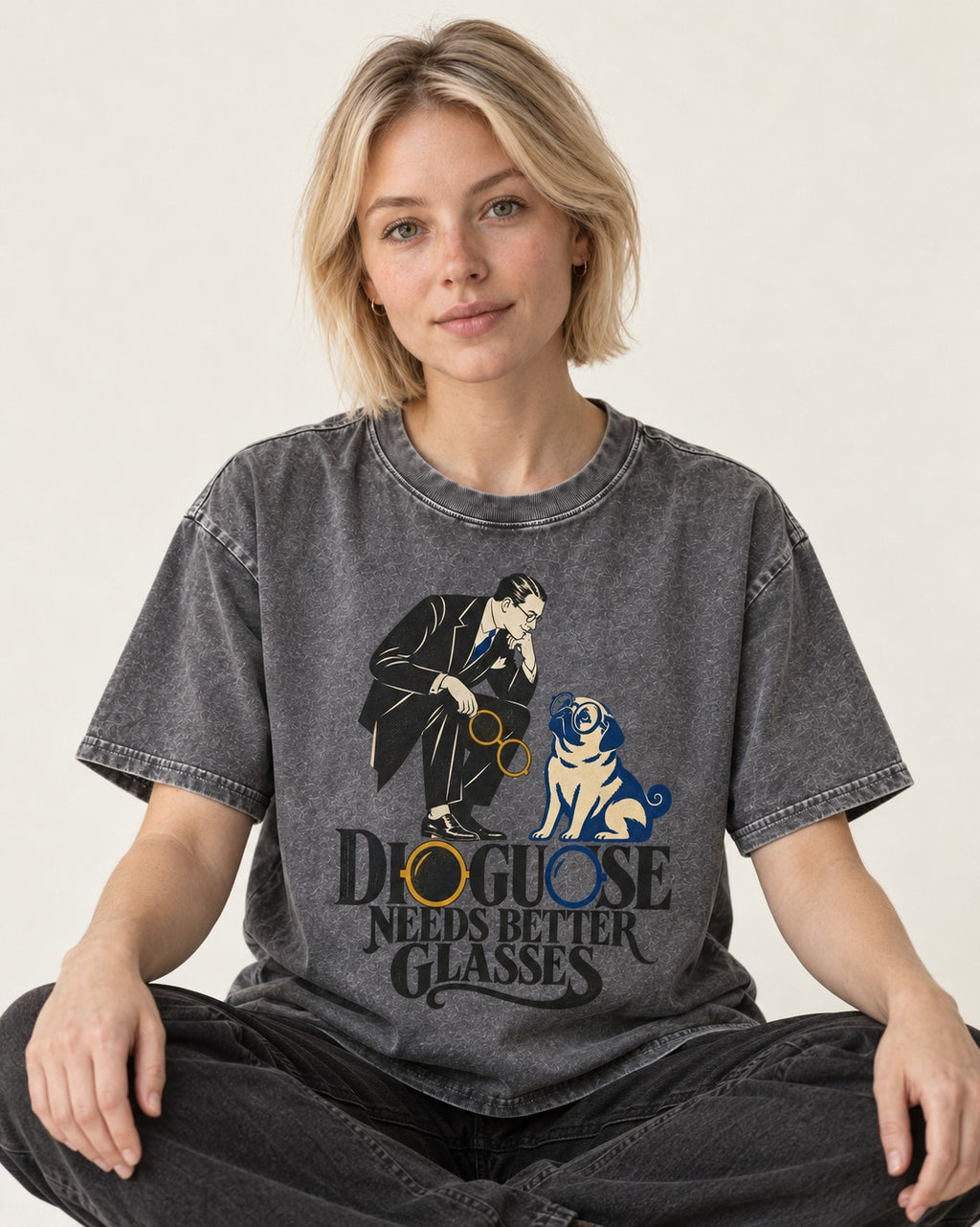 Pug Needs Better Glasses Washed Tee in Gray, worn by a seated model