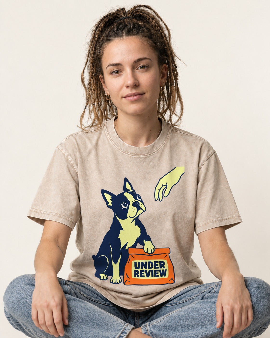 Boston Terrier Under Review Washed Tee in Apricot, worn by a seated model