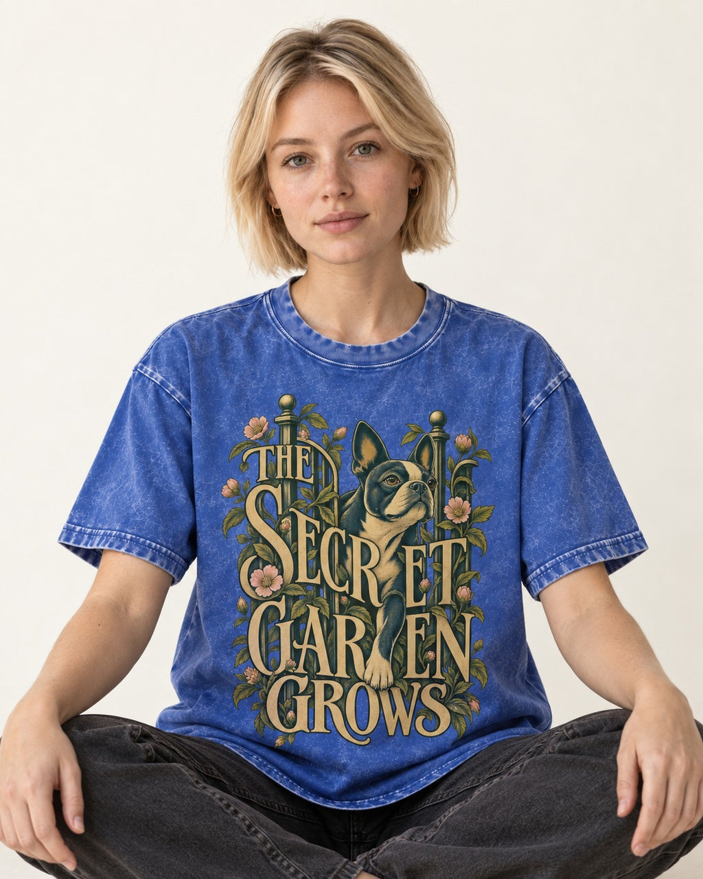 The Secret Garden Grows Boston Terrier Washed Tee in Royal Blue, worn by a seated model
