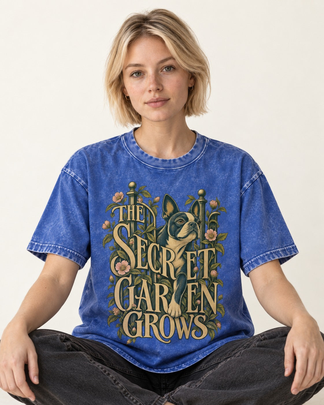 The Secret Garden Grows Boston Terrier Washed Tee in Royal Blue, worn by a seated model