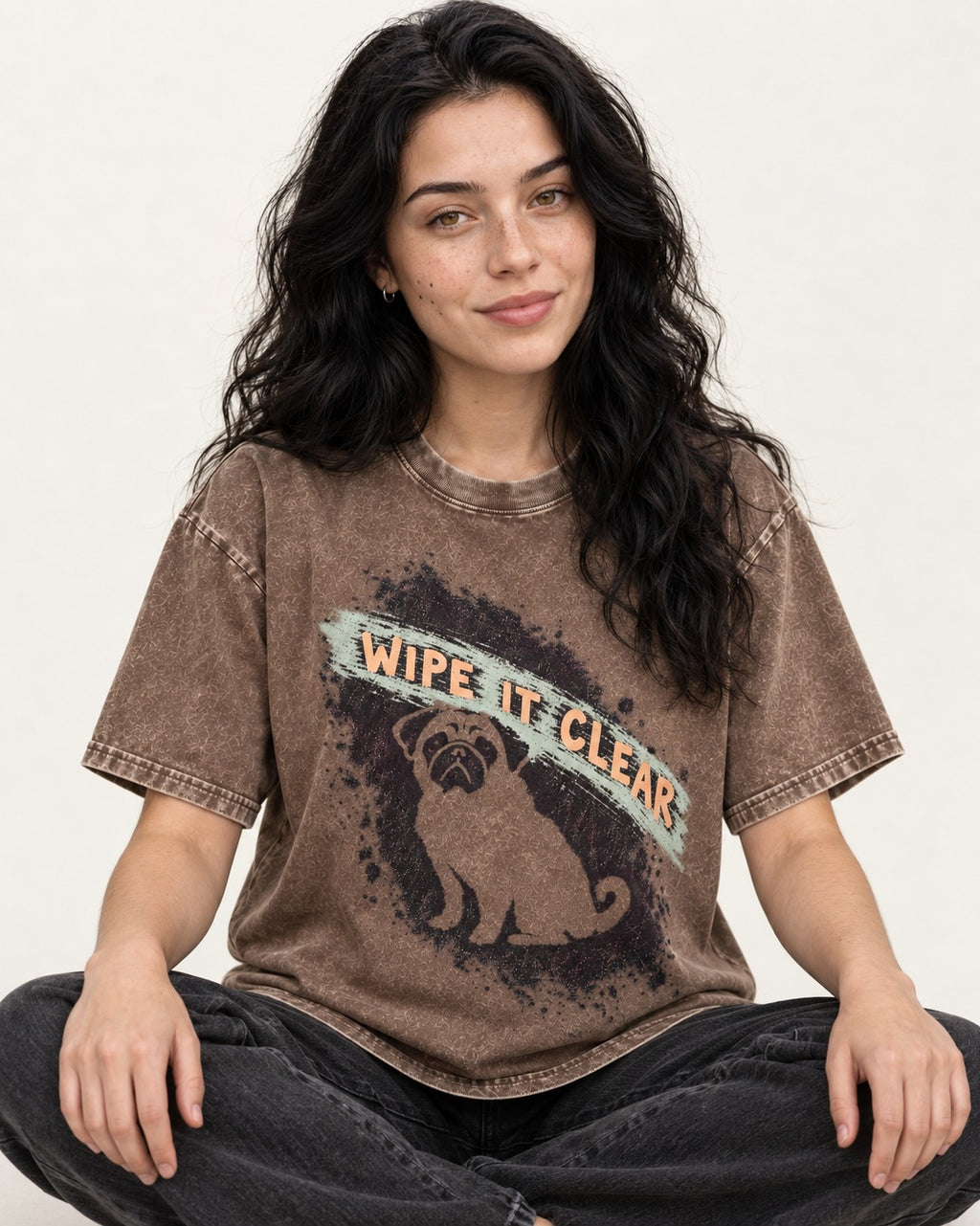 Pug Wipe It Clear Washed Tee in Coffee, worn by a seated model