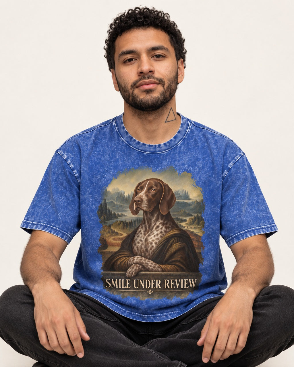 German Shorthaired Pointer Smile Under Review Renaissance Portrait Graphic Washed Tee in Royal Blue, worn by a seated model